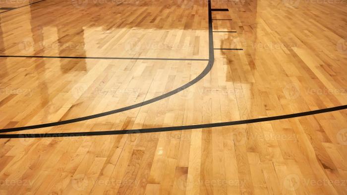 interior of empty modern basketball indoor sport court semigloss coating wooden floor artificial lights reflected photo 2 - Pasang Lantai Kayu Lapangan Basket LantaiParket.id