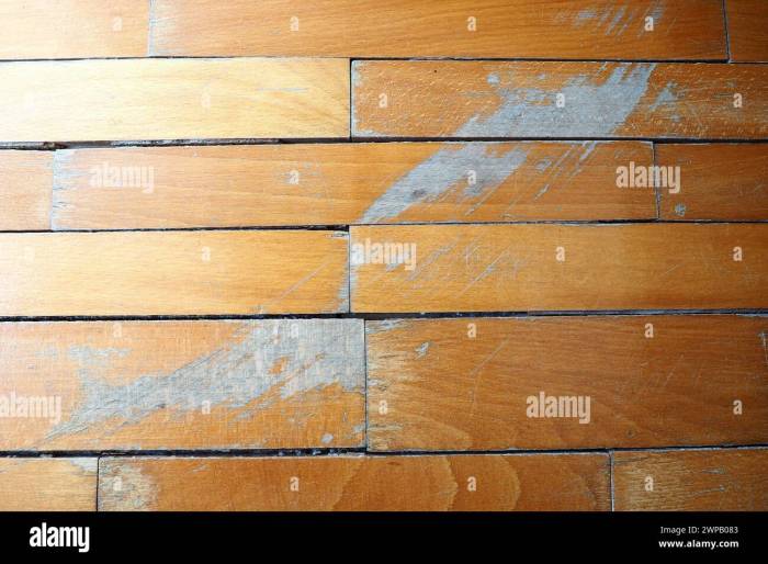 old scratched parquet flooring needs maintenance the parquet is damaged by scratches from prolonged use 2WPB083 - Cara Mengatasi Gores dan Noda Lantai Parket Lapangan Basket